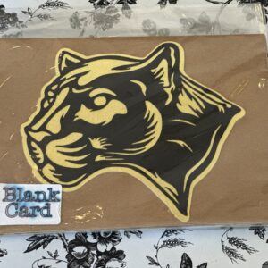 A black and gold panther sticker on a brown piece of paper.