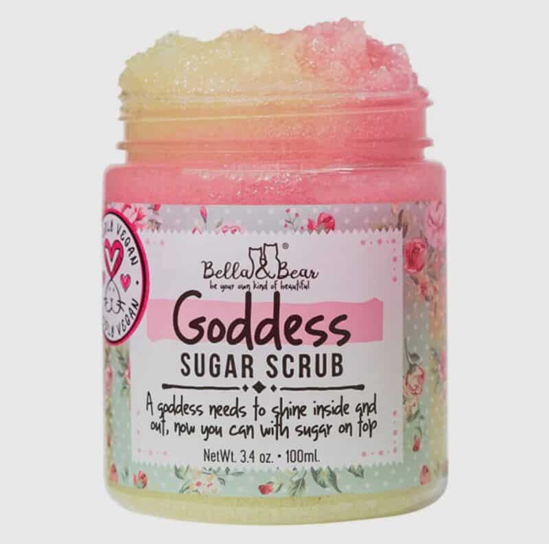 A jar of bella & bear sugar scrub with pink contents and floral packaging design.